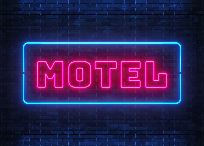Motel Neon Sign on Brick Wall