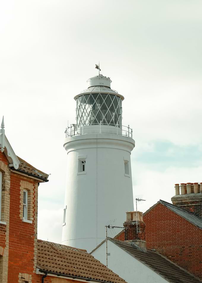 White Lighthouse with Coastal Buildings