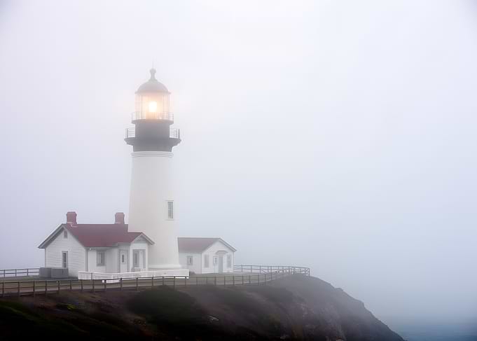 Lighthouse in Fog on Cliff