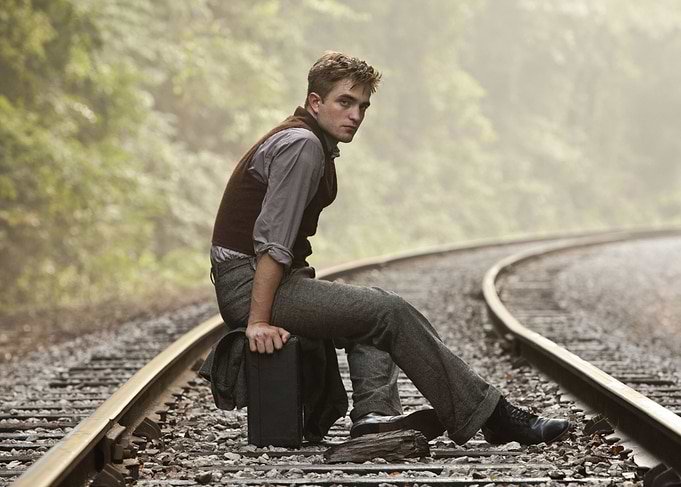 Man sitting on train tracks