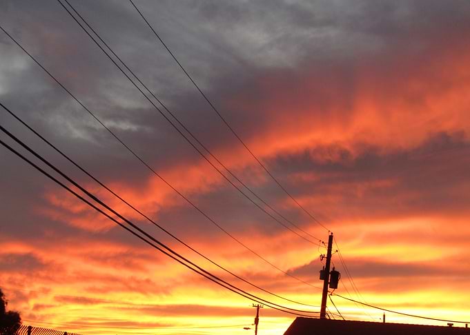Fiery Sunset Over Power Lines