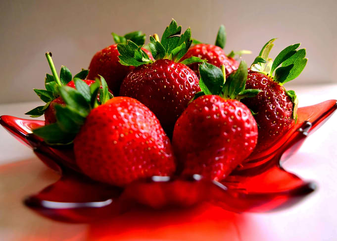 Fresh Strawberries in a Red Bowl