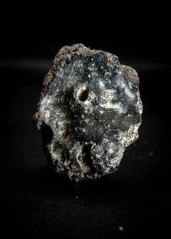 Close-up of a dark, textured mineral specimen