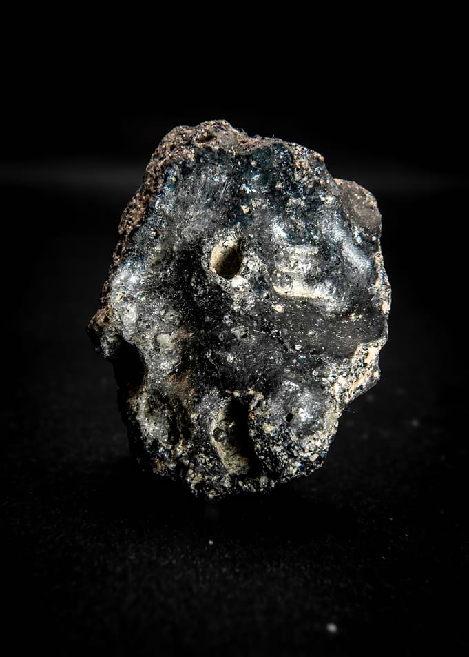 Close-up of a dark, textured mineral specimen