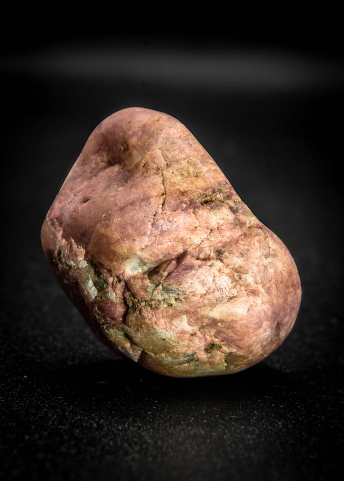 Close-up of a smooth, reddish-brown pebble