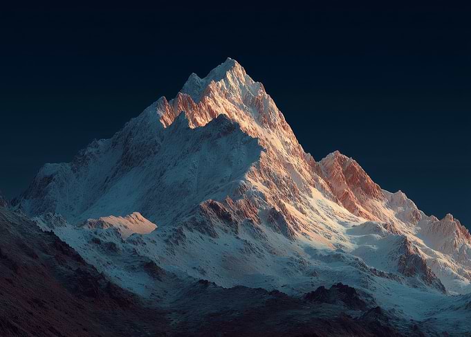 Snow-capped mountain peak at sunset