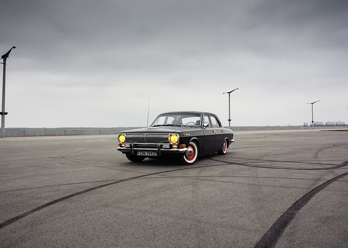 Classic Black Volga in huge asphalt lot