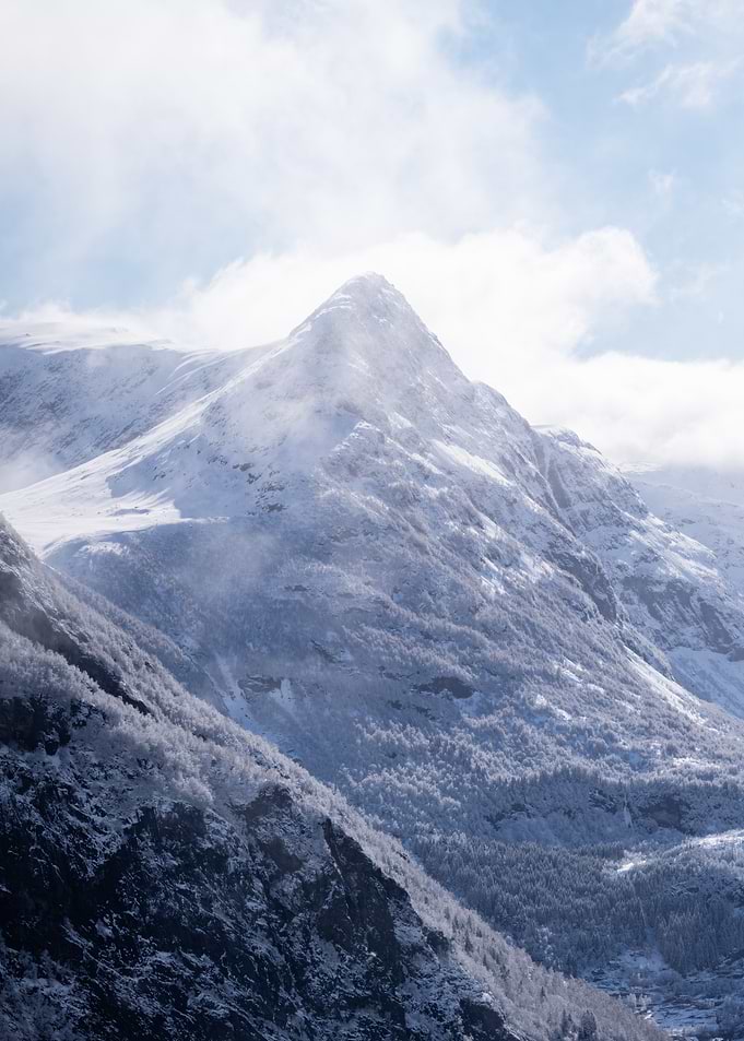 Snow-covered mountain peak in clouds