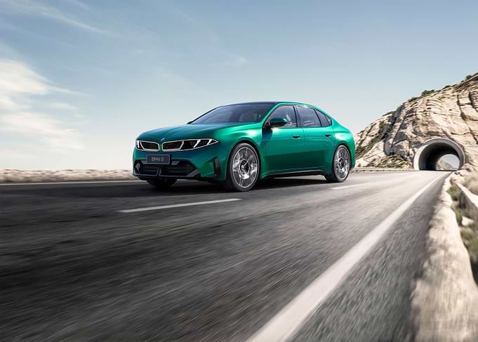 Green BMW M8 driving through a tunnel