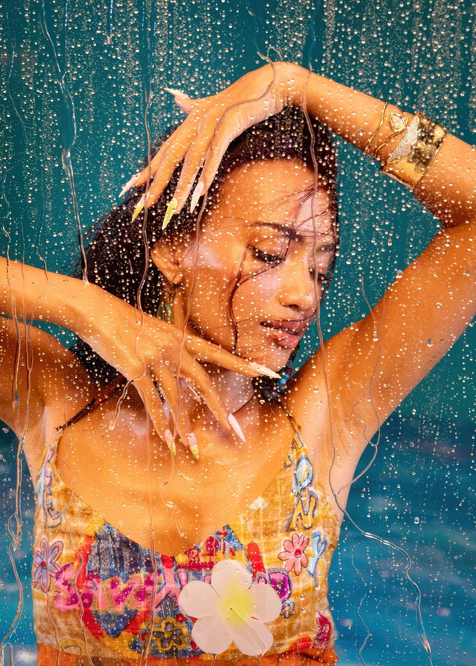 easter no na in patterned top behind water droplets