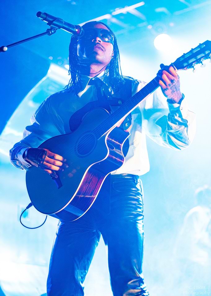Musician playing guitar on stage