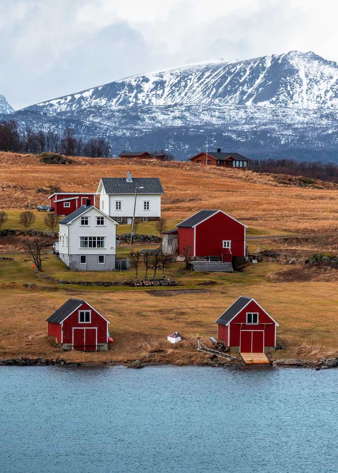 Norwegian Coastal Village with Snowy Mountains