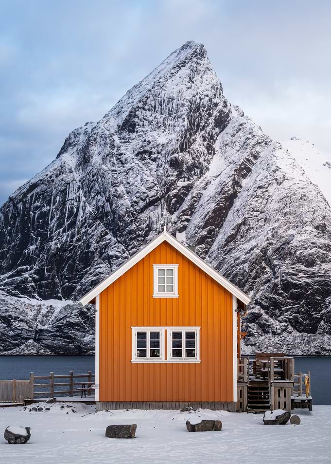 Orange cabin in snowy Norwegian landscape