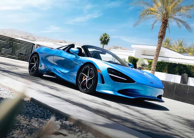 Blue McLaren Convertible on Sunny Driveway
