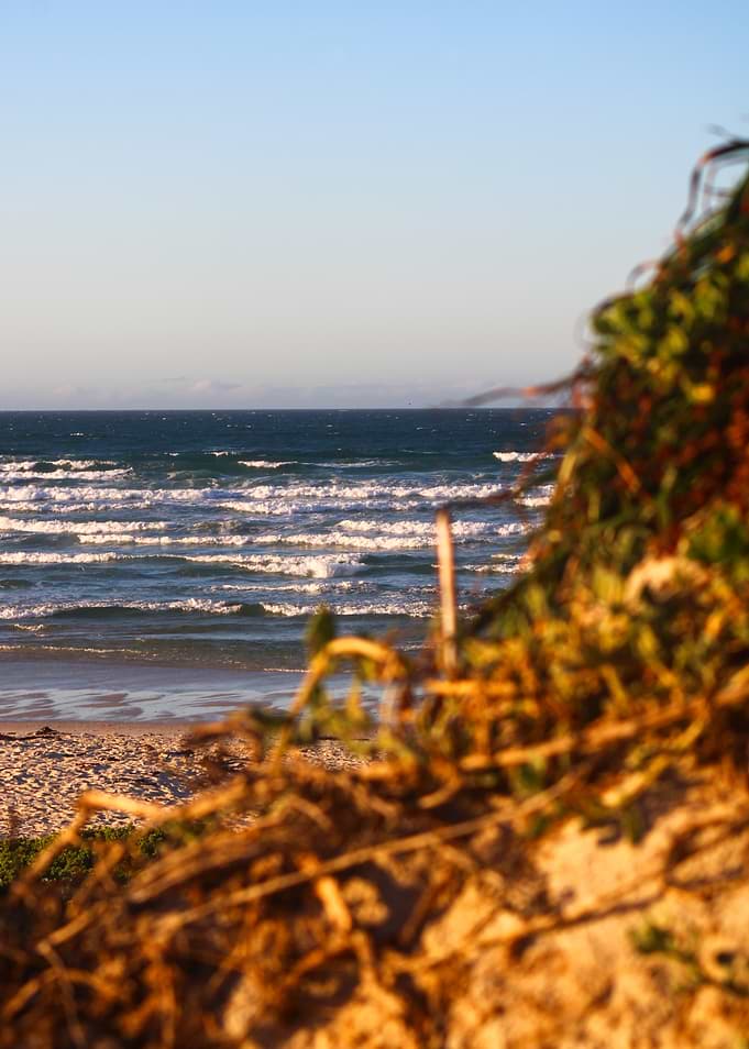 Ocean waves crashing on a sandy beach