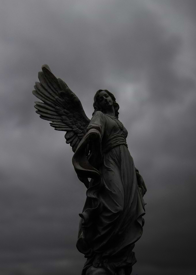Angel Statue Against Cloudy Sky
