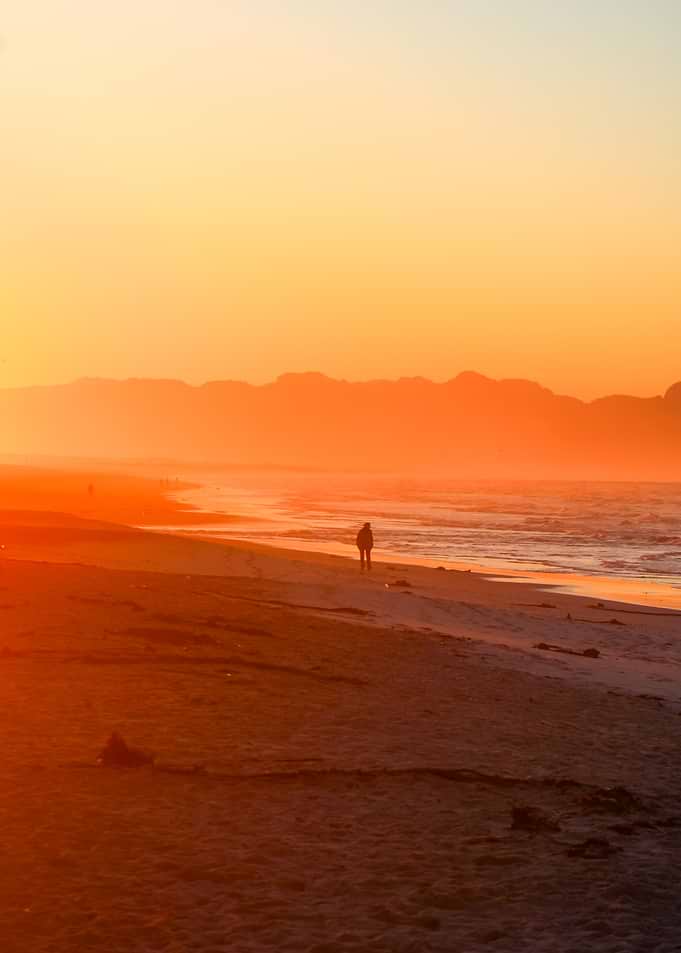 Sunset beach with lone figure