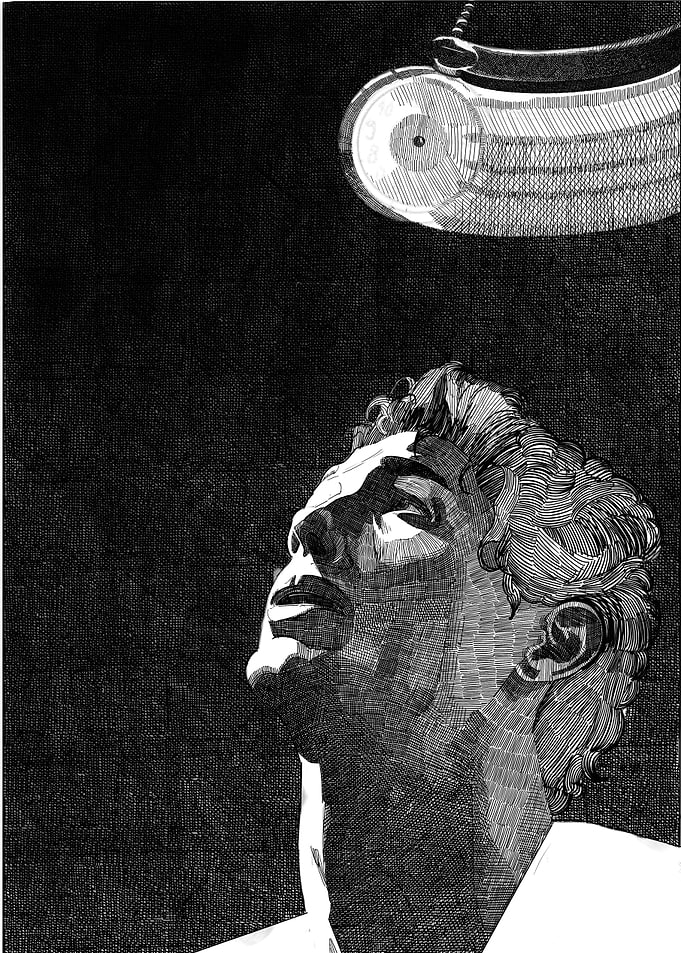 Man looking up at a light