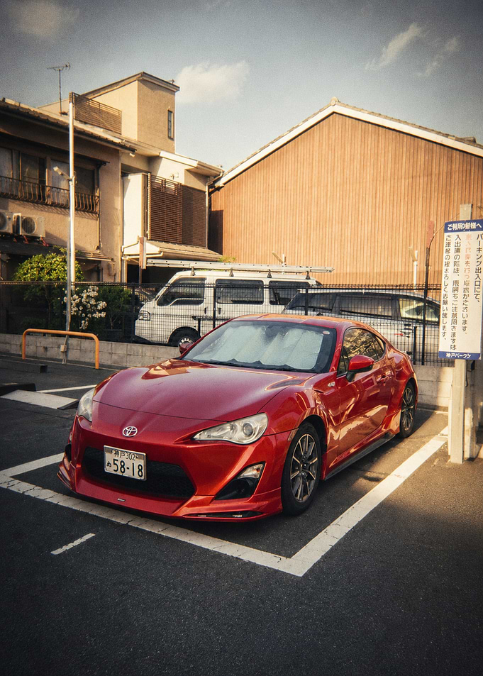 Red Sports Car in Japanese Parking Lot