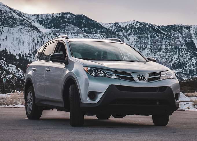 Silver Toyota RAV4 in Snowy Mountains