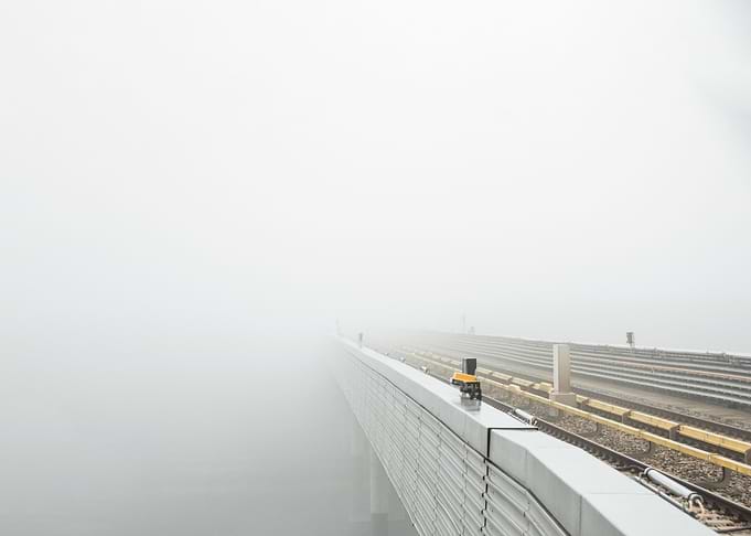 Misty train tracks on an elevated railway