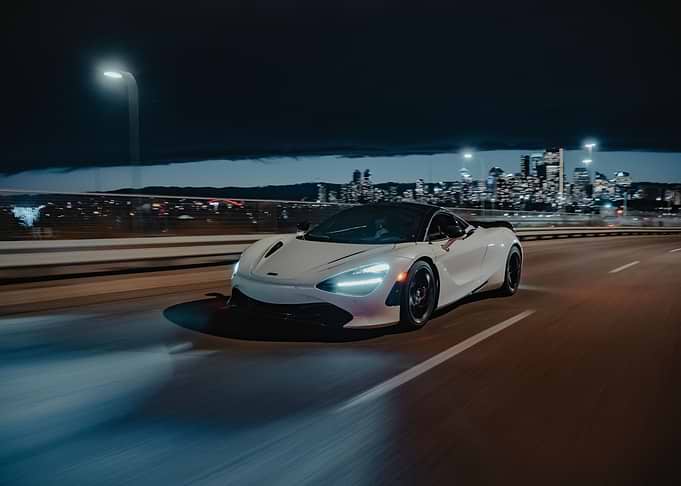 White McLaren 720S driving at night