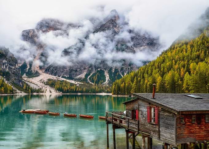 Mountain Lake with Boats and Cabin