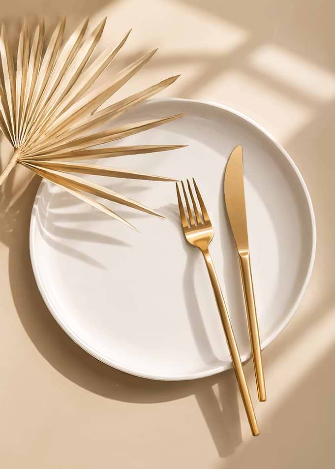 Elegant Table Setting with Golden Cutlery