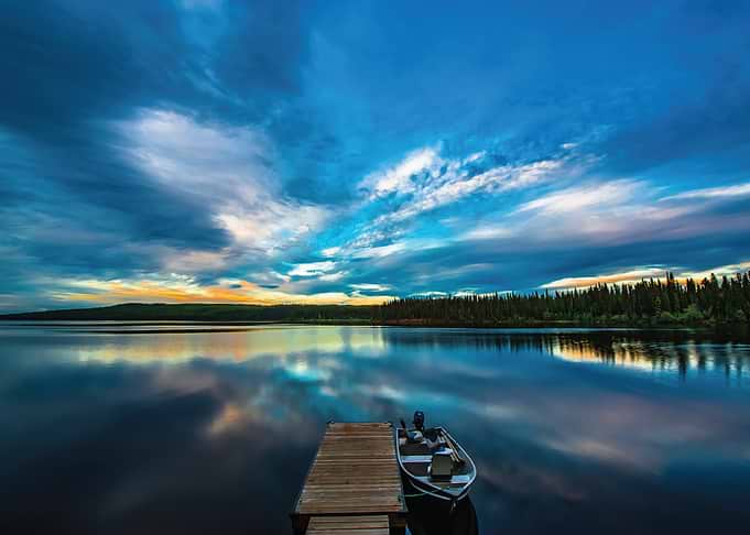 Serene Lake at Dusk with Dock and Boat