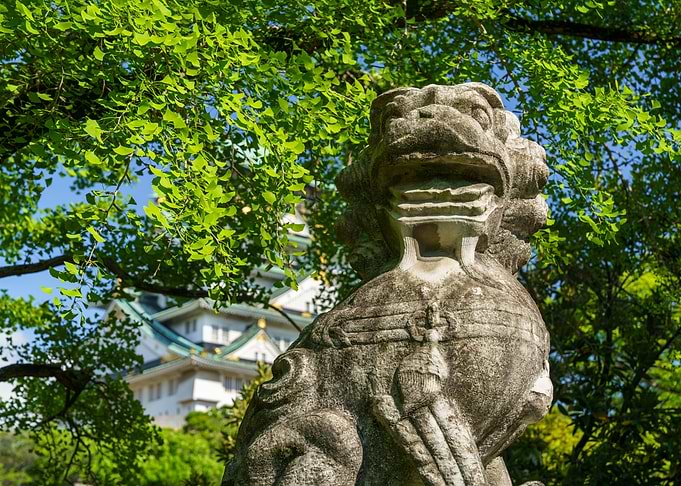 Stone Guardian and Japanese Osaka Castle