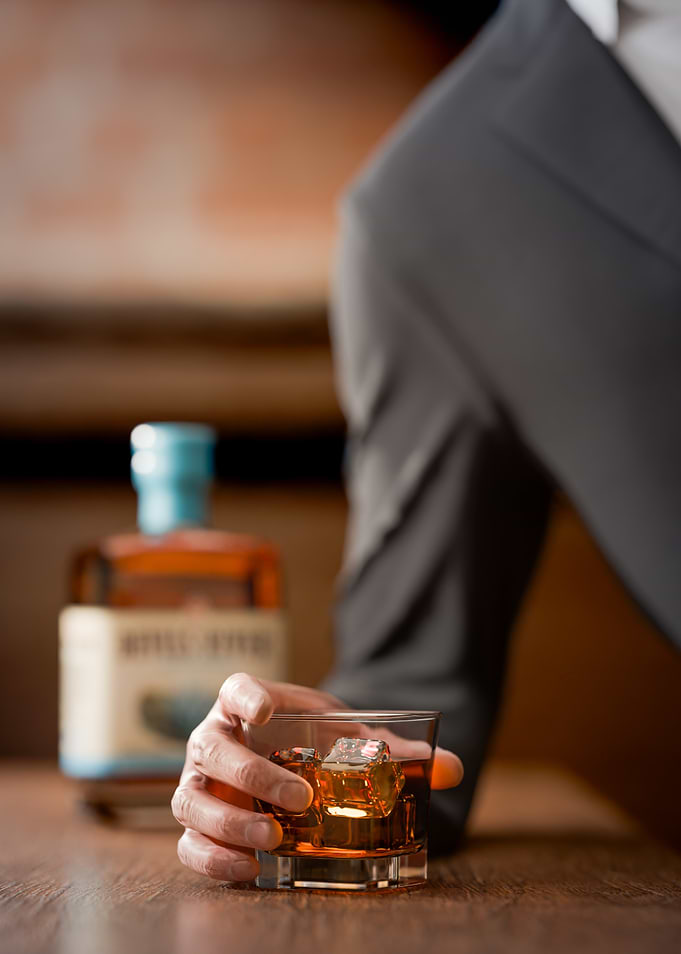 Man holding a glass of whiskey