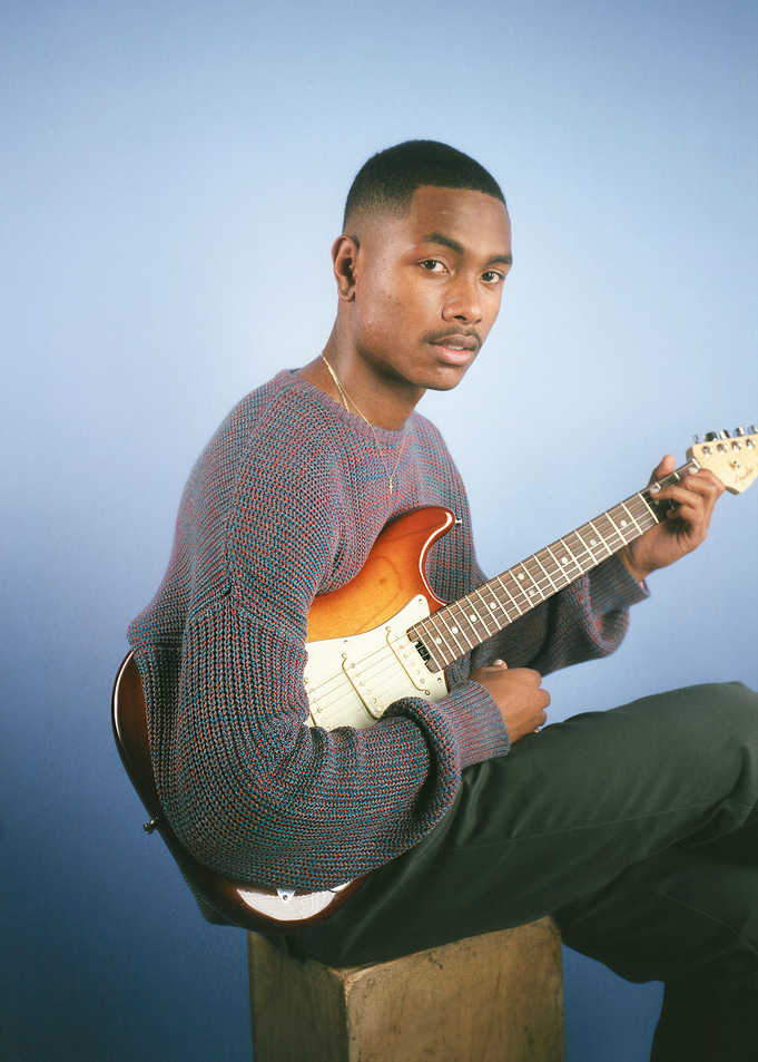 Man with Guitar on Blue Background