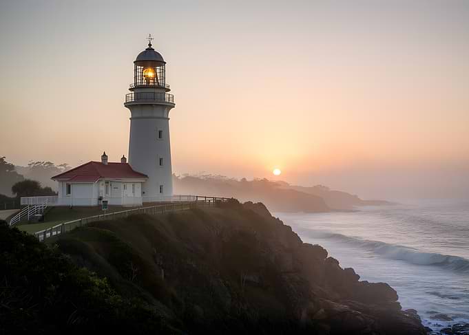 Lighthouse at Sunrise Over the Ocean