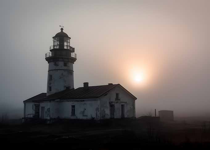 Misty Lighthouse at Sunrise