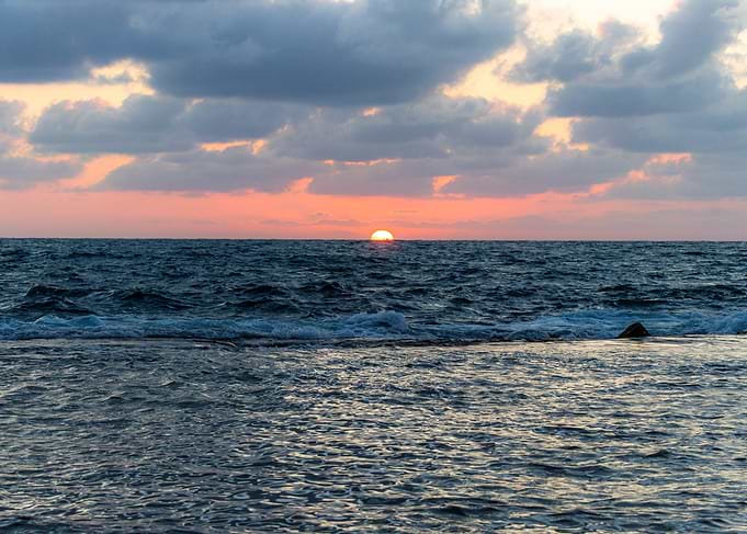 Sunset over the ocean with clouds