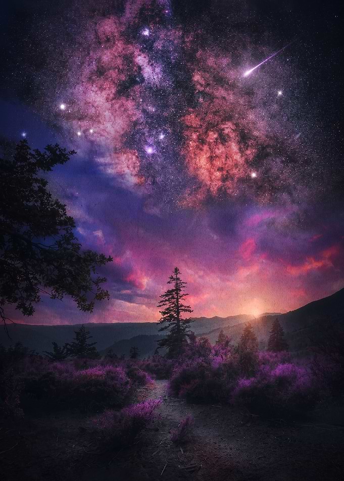 Cosmic Sunset Over a Mountain Landscape