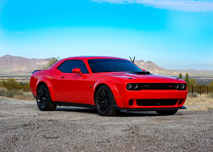 Red Dodge Challenger in Desert Landscape