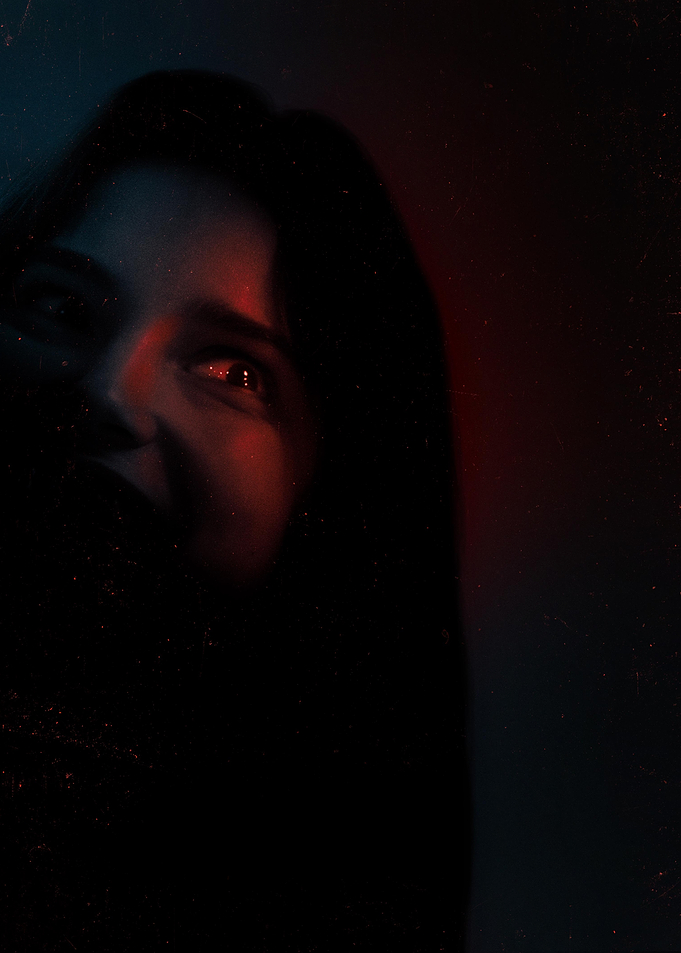 Close-up of a person's face with red and blue lighting