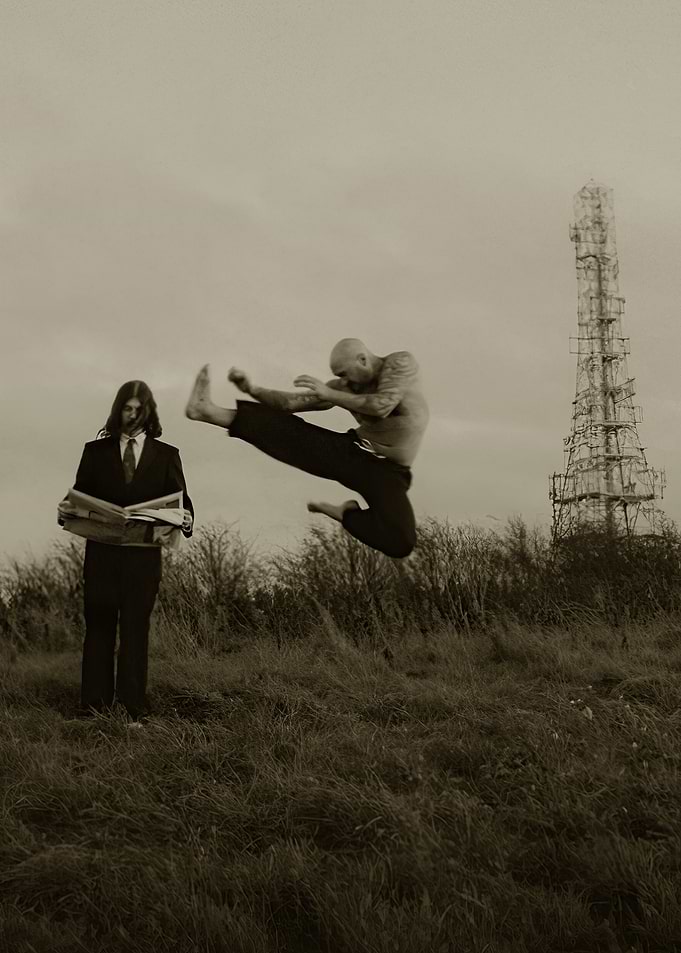 Martial Artist Kicks Near Man Reading Newspaper