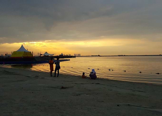 Sunset beach scene with people