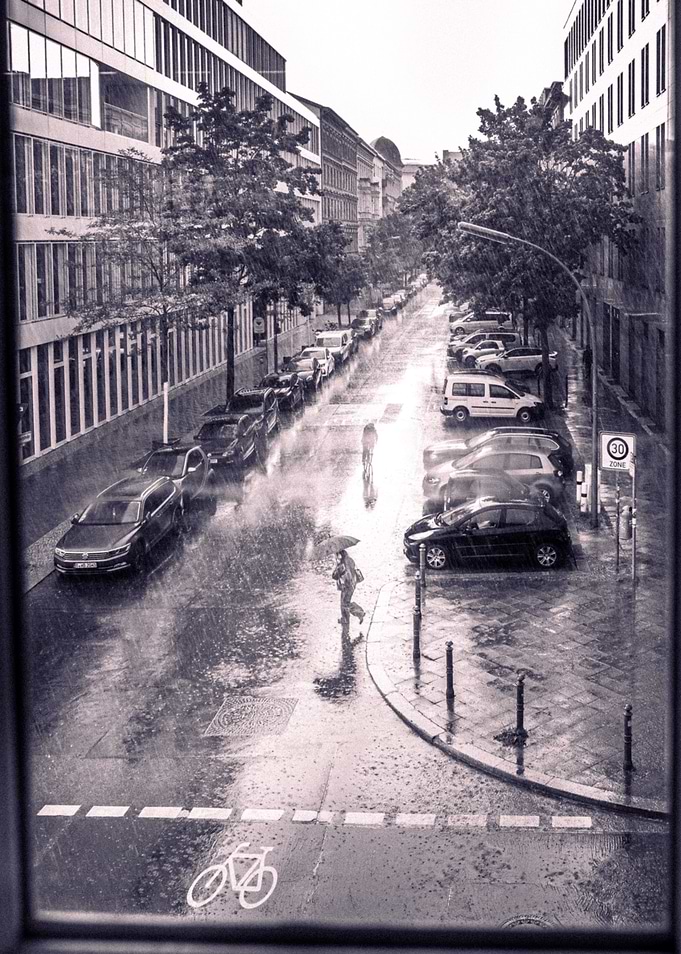 Rainy Berlin City Street with Pedestrian