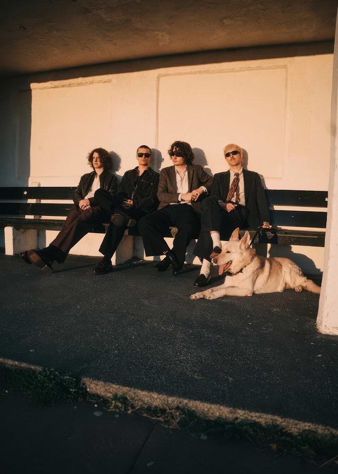 Four men and a dog on a bench