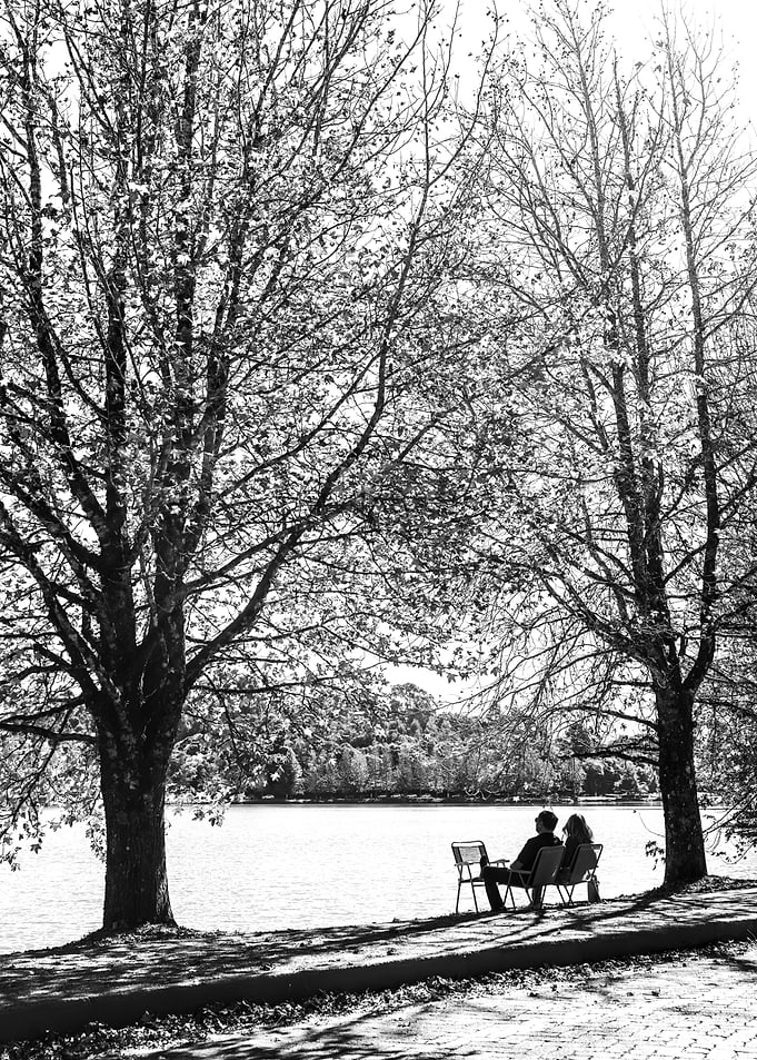 Couple sitting by a lake