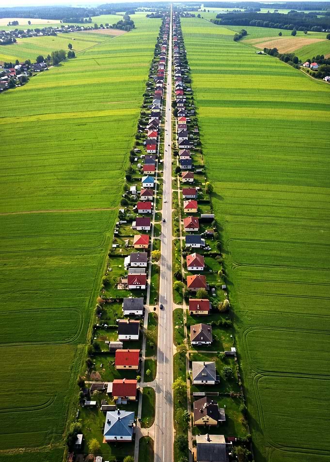 Aerial View of a Long Street Lined with Houses