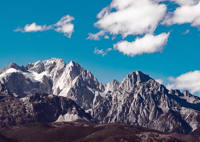 Majestic Mountain Range Under Blue Sky