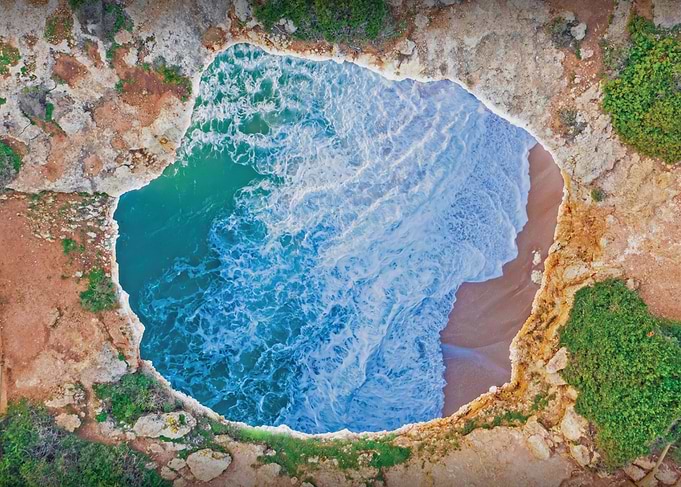 Aerial view of a sea cave and beach