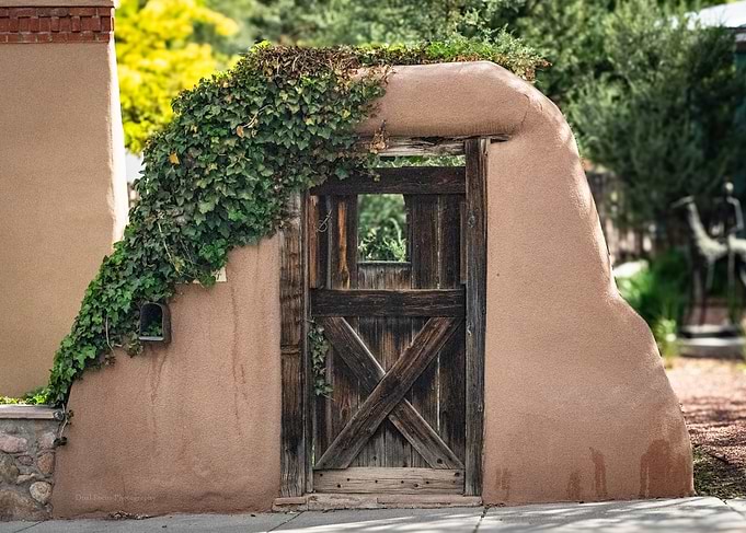 Rustic Adobe Wall with Wooden Gate