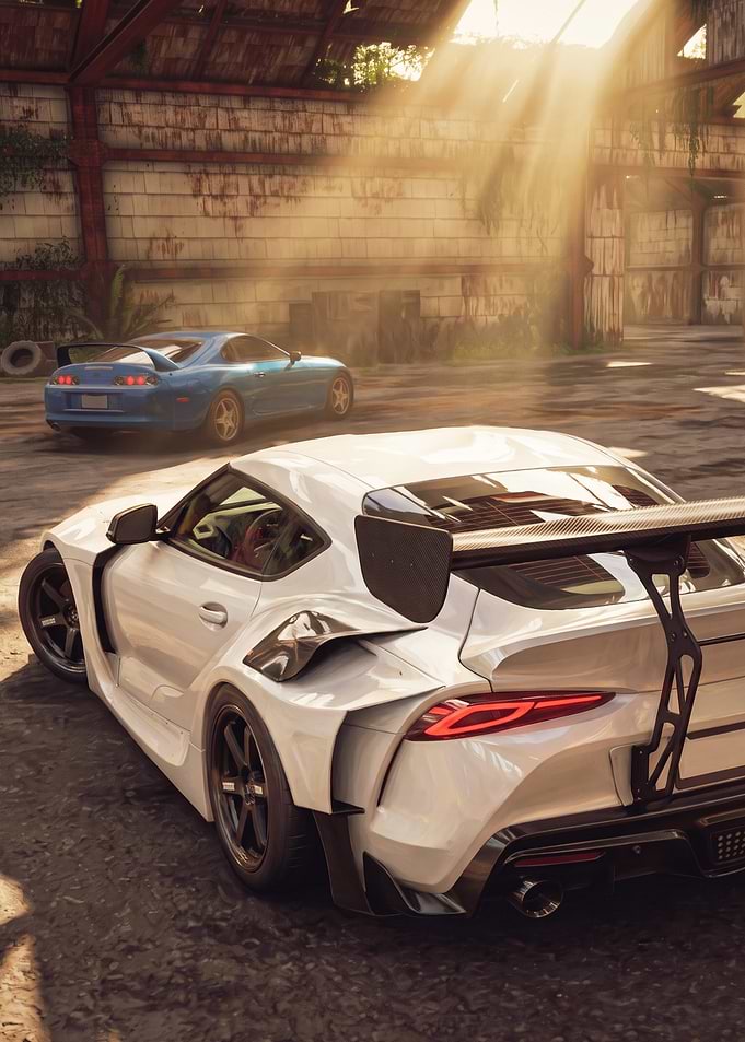 White and Blue Toyota Supras in Hangar