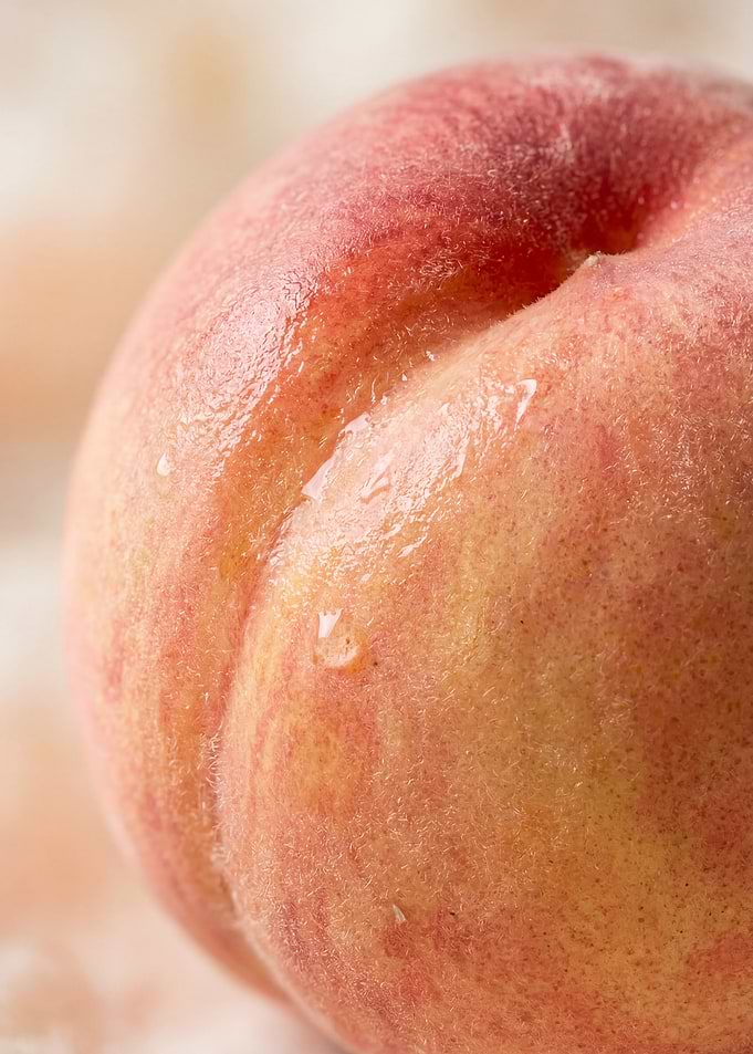 Close-up of a Fresh Peach with Water Droplets