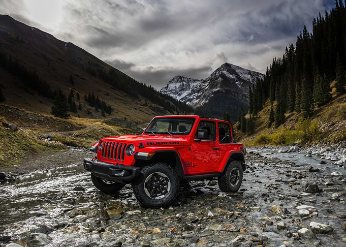 Red Jeep Wrangler Rubicon in Mountain Stream